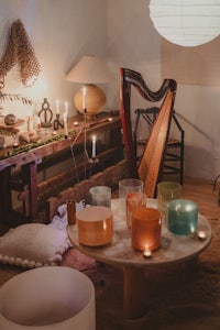 a room filled with candles and harps